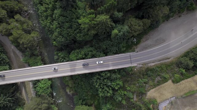 4K top-down drone view of the bridge connecting Lake Correntoso and Lake Nahuel Huapi in Neuqu&eacute;n, Argentina. The road crosses the landscape between two iconic Patagonian lakes.