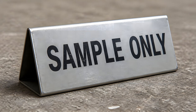 Metal triangular table sign with Sample Only text on concrete surface