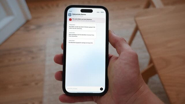 A fake follow up message after a data breach asks the user to upload an ID photo. Point of view shot with the phone held in the hand. Useful for staying one step ahead of scammers.
