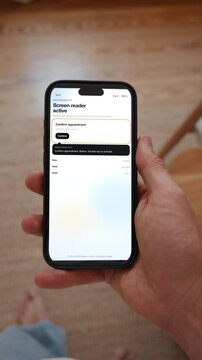 A screen reader focuses a button and the spoken announcement is shown next to it. Point of view shot in vertical format with the phone held in the hand. Useful for technology that includes everyone.
