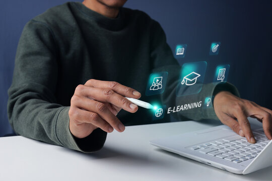 Closeup of Hand Interacting with Futuristic Hologram Education Interface Next to Laptop