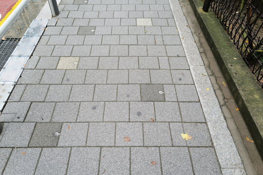 Exterior sidewalk architecture and pavement design decorated with concrete tiles and brick wall