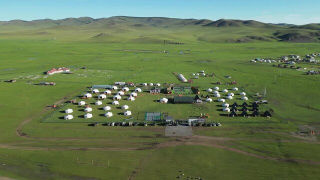 Aerial orbits yurt encampment of green Jaran Tsagaan Hot springs Resort