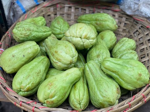 Fresh Green Chayote Squash Vegetables in Traditional Woven Basket