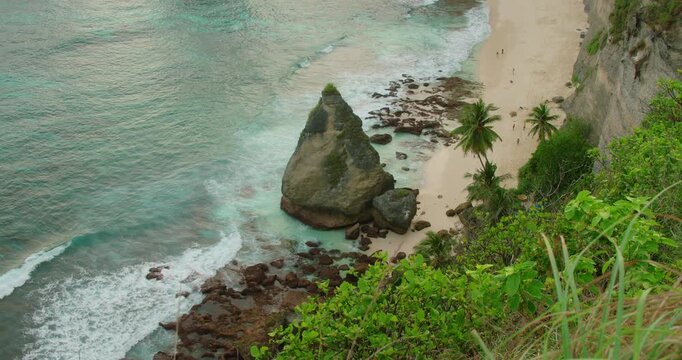 Scenic coastline with white sand and tropical plants at Diamond Beach Nusa Penida Island Bali