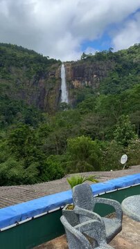 Scenic view of majestic Diyaluma waterfall cascading down rocks in Sri Lanka.