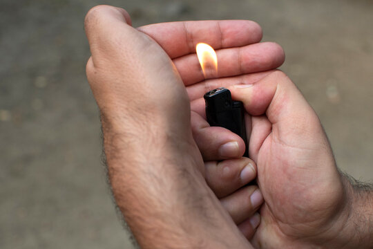 Male hands holding a lighter