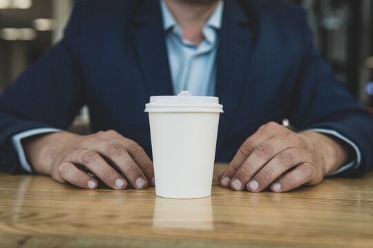 man and paper cup of coffee. Empty space for inscription. No face Unrecognizable person. Good morning concept. copy space