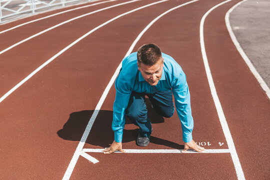 Start Concept. Top view of Man on Start Line, Get Ready for New Challenge. Metaphor Photo startup business. the beginning of a career. an office worker trains at the stadium.