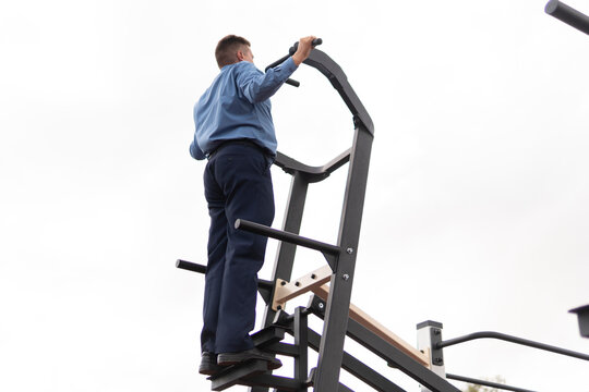 Businessman doing exercises on trainers in gym. a man in a business suit does exercises at the stadium.