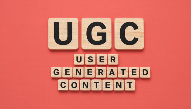 UGC user generated content concept spelled with wooden letter tiles on red background