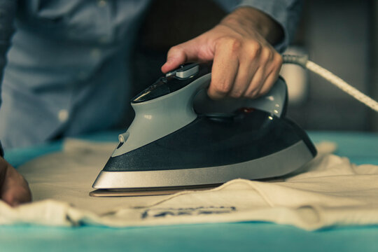 modern man lifestyle, ironing clothes and homework. closeup