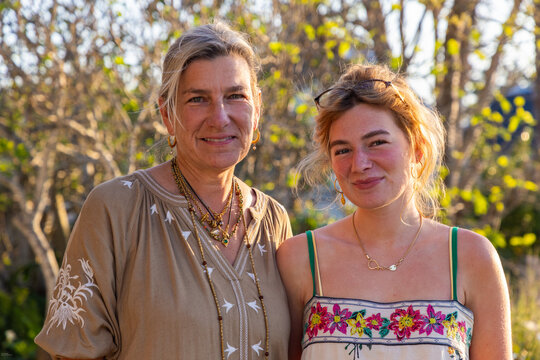 portrait of mother and 20 year old daughter in natural light smiling