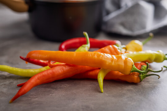 Colorful Assortment of Fresh Chili Peppers on Kitchen Countertop Ready for Spicy Cooking