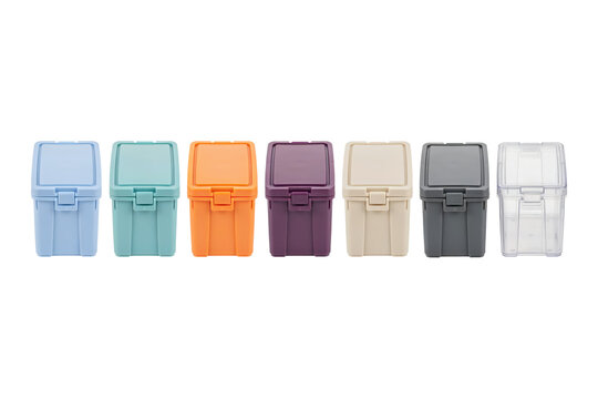 A row of seven small plastic storage boxes in various pastel and neutral colors isolated on a transparent background