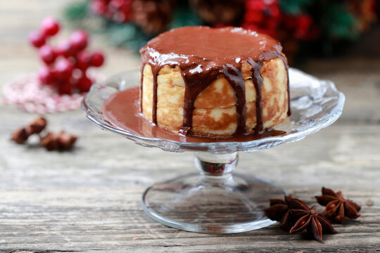 Portion of traditional Christmas cheesecake covered with chocolate.