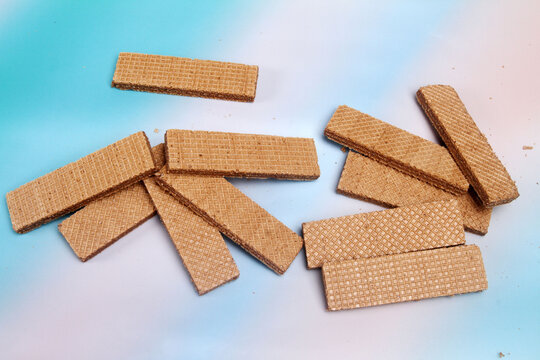 wafer cookies on color background
