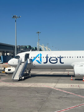 AJet passenger aircraft parked at an airport gate with boarding stairs. Antalya, Turkiye - September 7, 2026. AJet is a Turkish low-cost airline operating domestic flights and international flights.