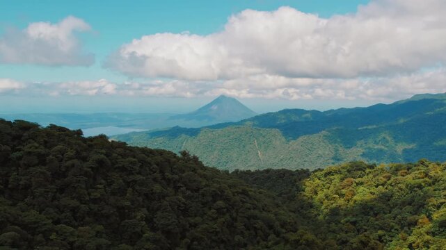 View of lush Monteverde rainforest and distant Arenal volcano in Costa Rica