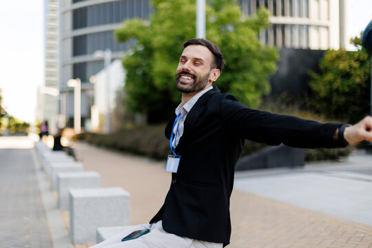 Happy businessman enjoying freedom and success outdoors