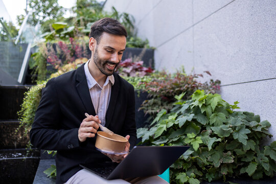 Business man eating lunch while working outdoors