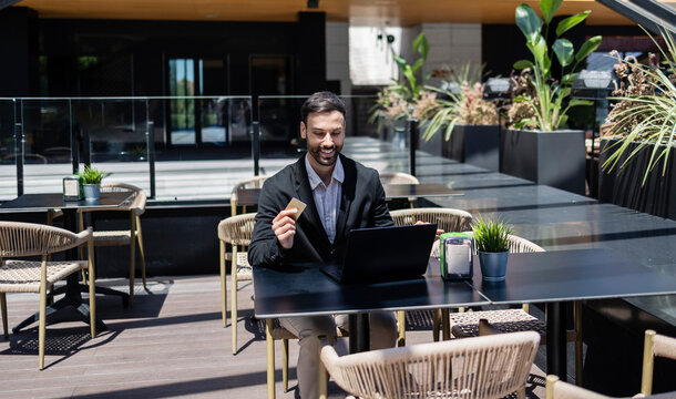 Businessman making online payment with credit card and laptop