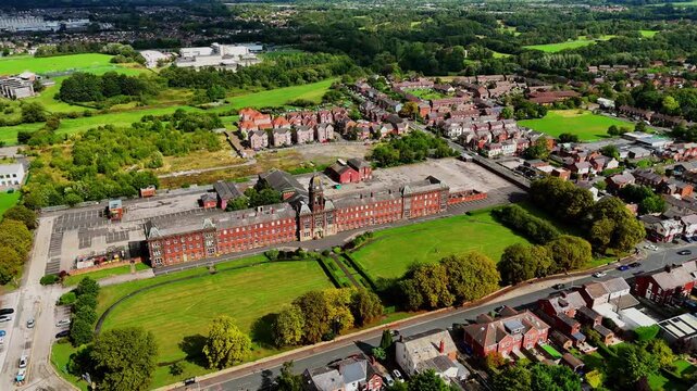 Aerial tracking shot of historic Fulwood building in Preston on a sunny day