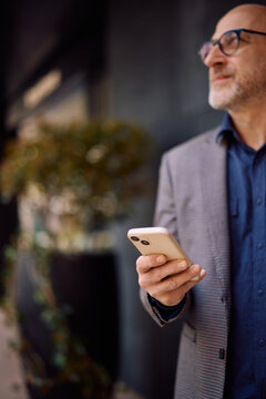 Close up of businessman using smart phone app.