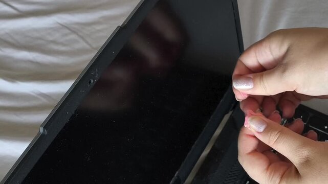 Woman blocking the built-in camera of a laptop with modeling clay, symbolizing digital privacy, personal data protection, cybersecurity awareness and prevention of webcam surveillance.