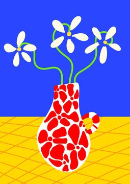 White flowers sit in a patterned vase on a yellow checkered table