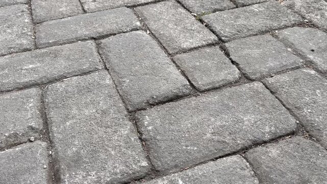 Perspective view of grey concrete paving blocks texture background