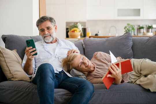 Relaxed couple spending leisure time together at home on the sofa
