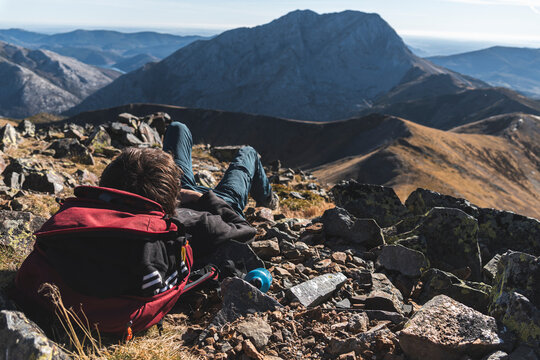Young male explorer on rock in mountain