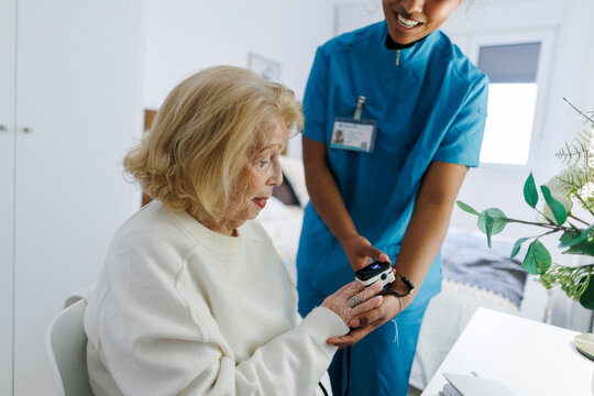 Home nurse supporting senior during relaxed healthcare visit