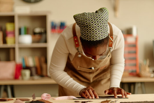Female artisan working on a handmade craft at a workshop table