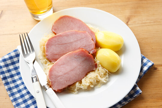 Smoked pork chop, with potatoes and sauerkraut on plate