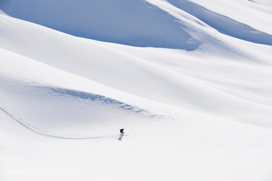 A man goes ski touring on the snowy slopes of Seiseralm in Italy