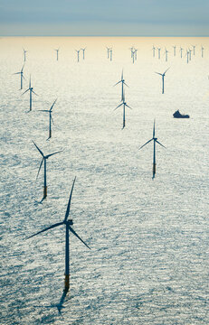 Offshore wind turbines and boat in North Sea near the Netherlands