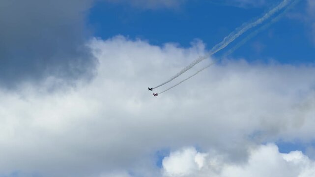 Aerobatic Biplanes Performing Formation Flight with Smoke Trails