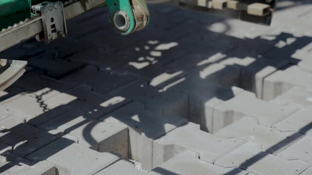 Mechanical paver clamp installing interlocking concrete blocks