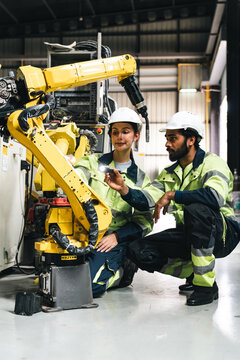 Industrial robot factory worker technician automation manufacturing