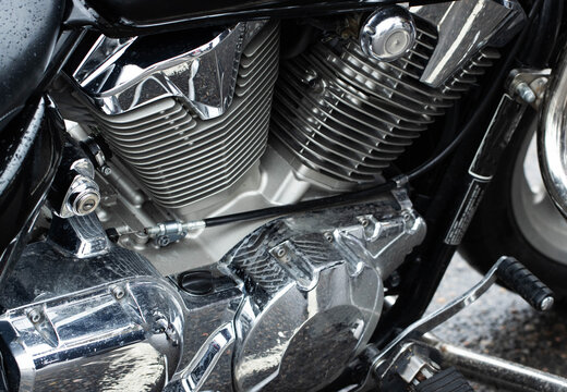 Close-up of V-twin motorcycle engine featuring intricate chrome details and cooling fins, showcasing power and engineering of bike culture machine
