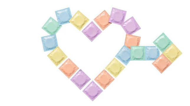 Colorful condom wrappers arranged in a heart shape isolated on a plain white background with pastel colored condom arranged form responsibility contraceptive prophylactic protection healthcare