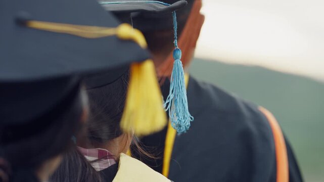 University Graduates Wearing Graduation Caps and Gowns at Ceremony