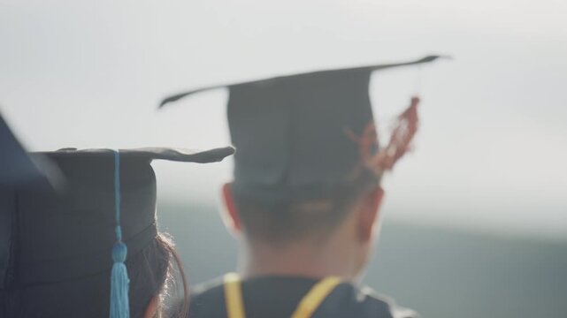 Close Up Rear View of Graduates Wearing Colorful Academic Tassels