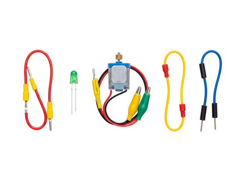 Electric DC motor jumper wires LED light electronic circuit components set isolated on black background for STEM science education physics experiments DIY kit prototype prototyping project hardware.