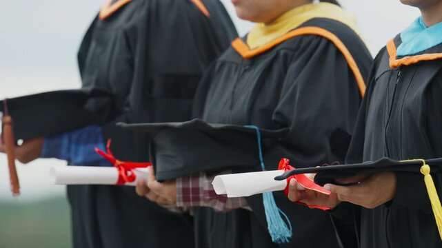University Graduates Holding Diplomas During Graduation Ceremony