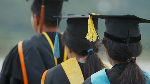 Rear View of University Graduates Wearing Academic Caps and Gowns