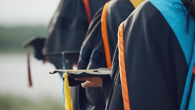 University Graduates Holding Graduation Caps and Diplomas at Ceremony
