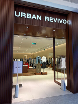 Hanoi, Vietnam - September, 5, 2026: A modern retail store exterior with a prominent sign reading 'URBAN REVIVO'. Mannequins display various clothing styles. 